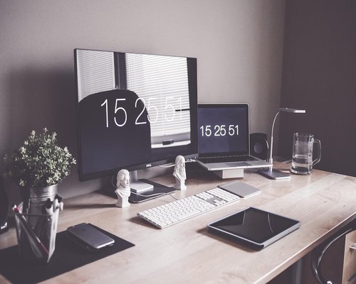 A well lit desk setup with ergonomic chair and proper monitor height